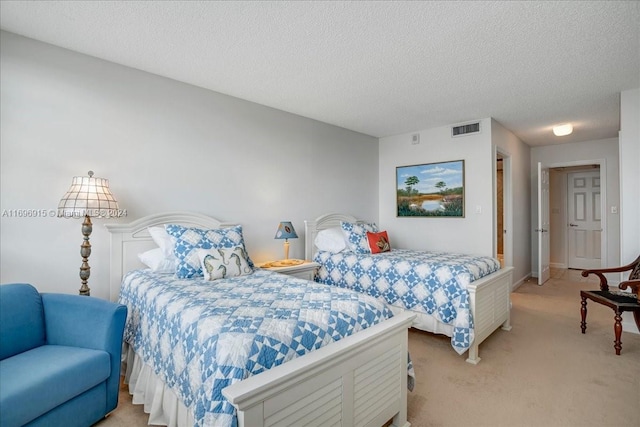 carpeted bedroom featuring a textured ceiling