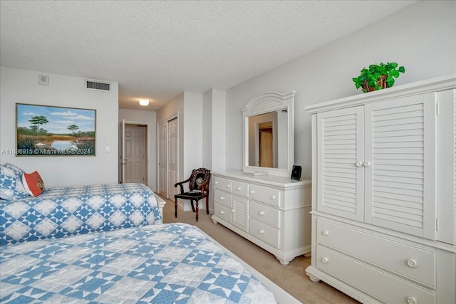 carpeted bedroom featuring a textured ceiling