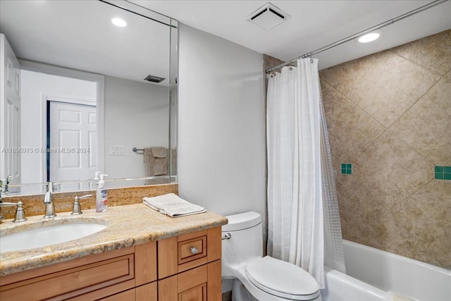 full bathroom with vanity, toilet, and shower / tub combo with curtain