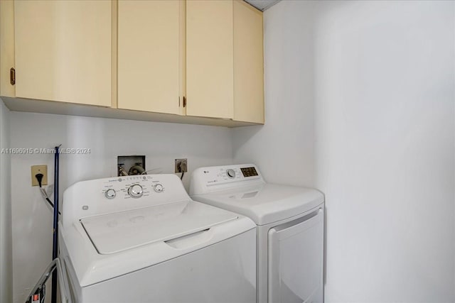 laundry room featuring cabinets and washer and dryer