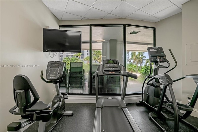 exercise room featuring a paneled ceiling