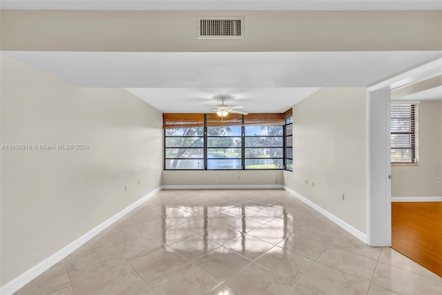 empty room featuring light wood-type flooring and ceiling fan