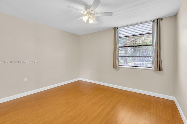 empty room featuring wood-type flooring and ceiling fan