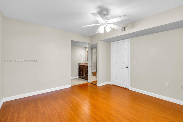 empty room featuring hardwood / wood-style flooring and ceiling fan