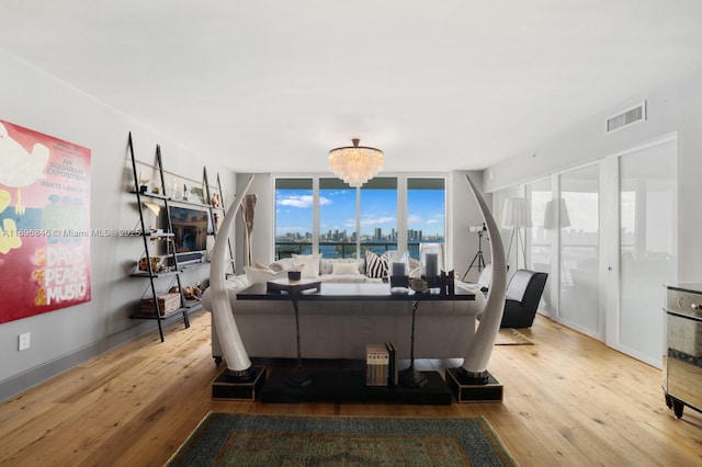 living room featuring a notable chandelier and light hardwood / wood-style floors