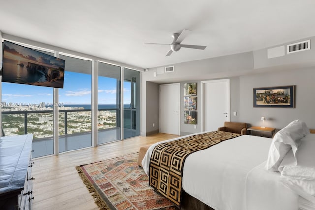 bedroom with ceiling fan, floor to ceiling windows, light hardwood / wood-style floors, and access to outside