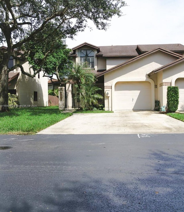 view of front of home with a garage and a front yard