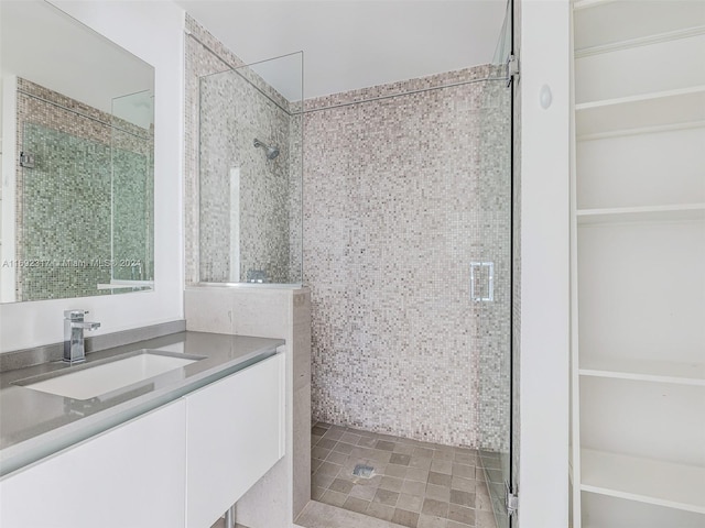 bathroom featuring a tile shower and vanity