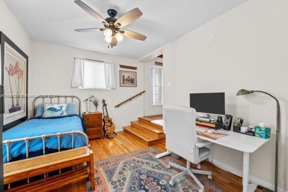 bedroom with hardwood / wood-style flooring and ceiling fan