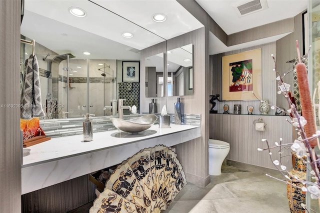 bathroom with vanity, a shower with shower door, and toilet