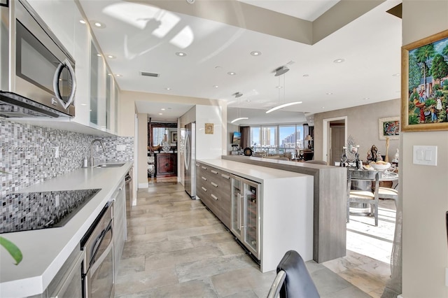 kitchen with white cabinets, sink, appliances with stainless steel finishes, and tasteful backsplash