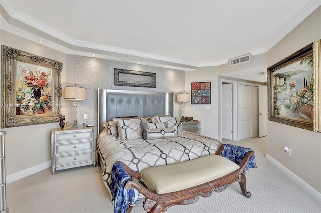 bedroom featuring light colored carpet, a closet, and ornamental molding