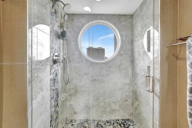 bathroom with a shower with shower door