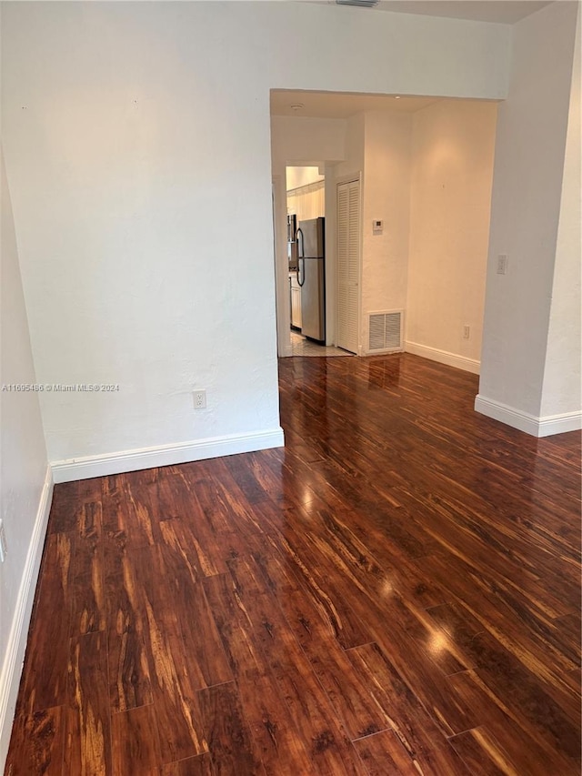 spare room with dark wood-type flooring