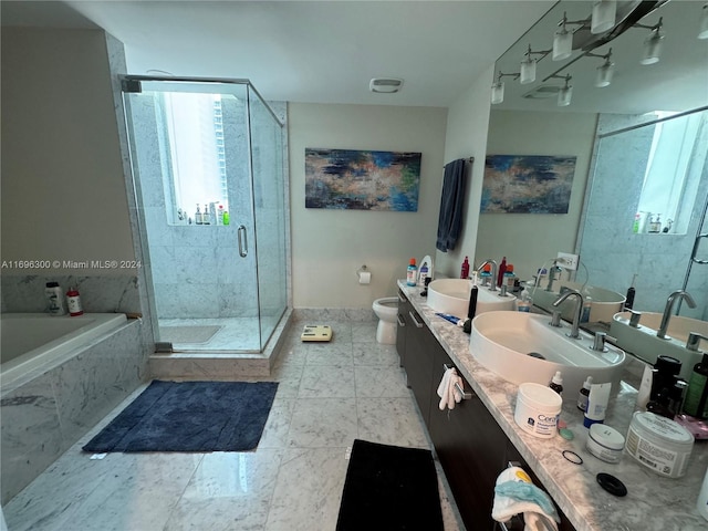 full bathroom with vanity, shower with separate bathtub, and toilet