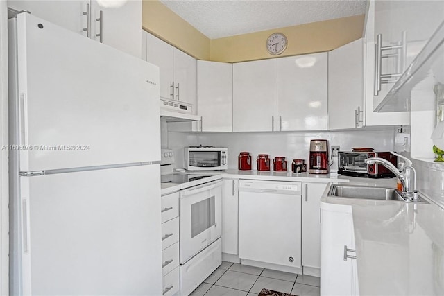 kitchen with white cabinetry, sink, white appliances, and a textured ceiling