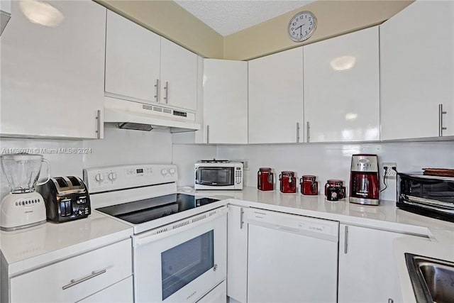 kitchen featuring white cabinetry, sink, white appliances, and a textured ceiling