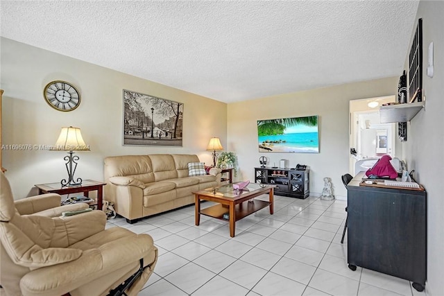 1015 SW 11th Ave Unit 11K, Hallandale Beach, FL 33009 - living room featuring a textured ceiling and light tile patterned floors