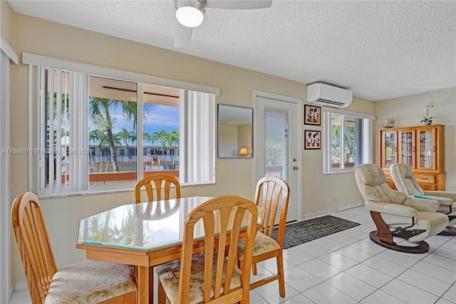 dining area featuring an AC wall unit, ceiling fan, and light tile patterned flooring