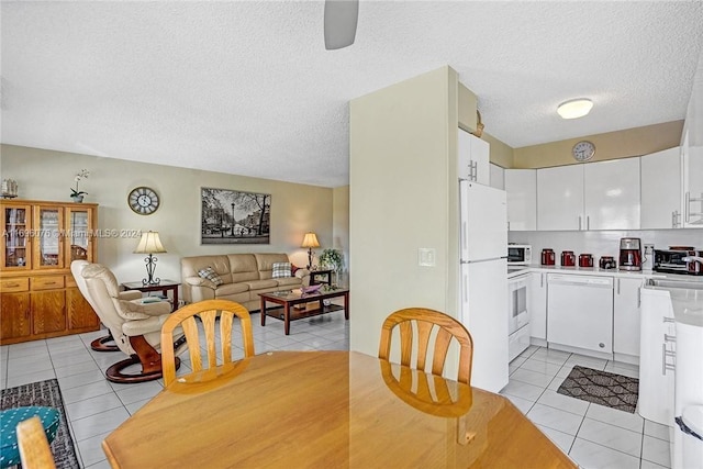 1015 SW 11th Ave Unit 11K, Hallandale Beach, FL 33009 - dining area featuring light tile patterned flooring, a textured ceiling, and a ceiling fan