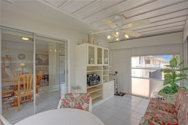 sunroom featuring ceiling fan and wood ceiling