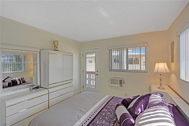 1015 SW 11th Ave Unit 11K, Hallandale Beach, FL 33009 - bedroom with a wall mounted air conditioner, a textured ceiling, and multiple windows