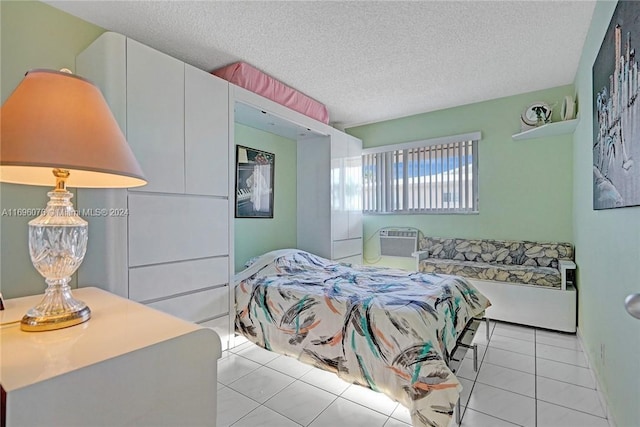 1015 SW 11th Ave Unit 11K, Hallandale Beach, FL 33009 - bedroom with light tile patterned floors, a textured ceiling, and a wall mounted air conditioner