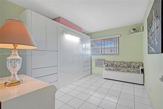 1015 SW 11th Ave Unit 11K, Hallandale Beach, FL 33009 - bathroom with a textured ceiling, tile patterned floors, and a wall unit AC