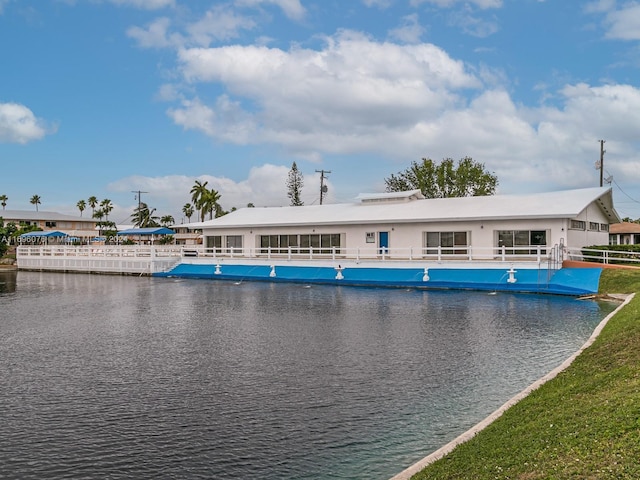 view of pool with a water view and a yard