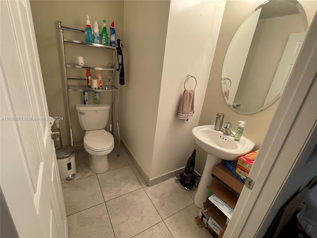 bathroom featuring sink, tile patterned flooring, and toilet