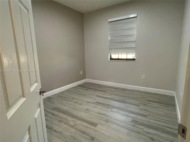 unfurnished room with light wood-type flooring