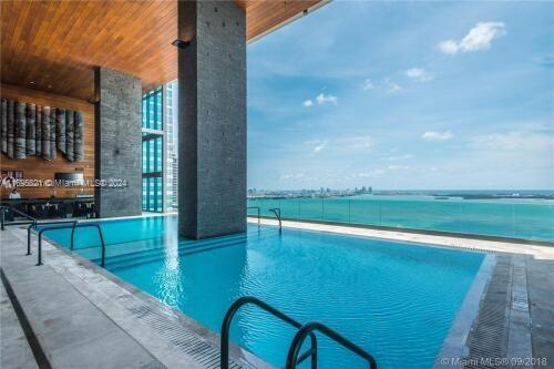 view of swimming pool featuring a water view