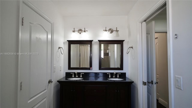 bathroom featuring a sink and double vanity