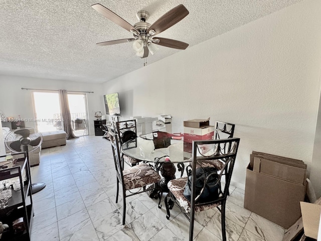 dining room featuring ceiling fan and a textured ceiling