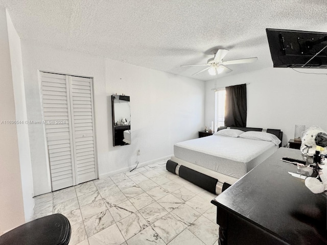 bedroom with ceiling fan, a textured ceiling, and a closet