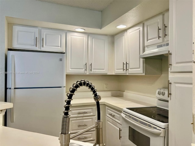 kitchen with a textured ceiling, white cabinets, white appliances, and ventilation hood