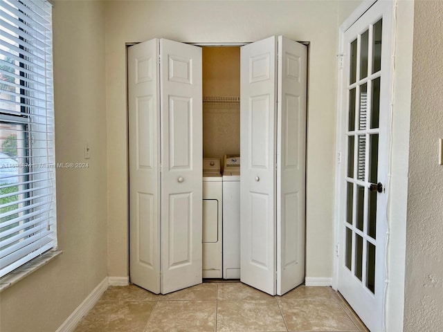 interior space featuring independent washer and dryer, a closet, and light tile patterned flooring