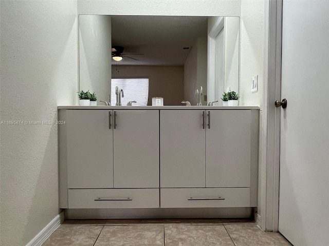 bathroom featuring tile patterned flooring, ceiling fan, and sink