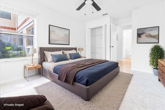 tiled bedroom with visible vents, ceiling fan, and baseboards