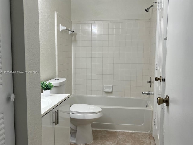 full bathroom featuring vanity, tiled shower / bath combo, and toilet