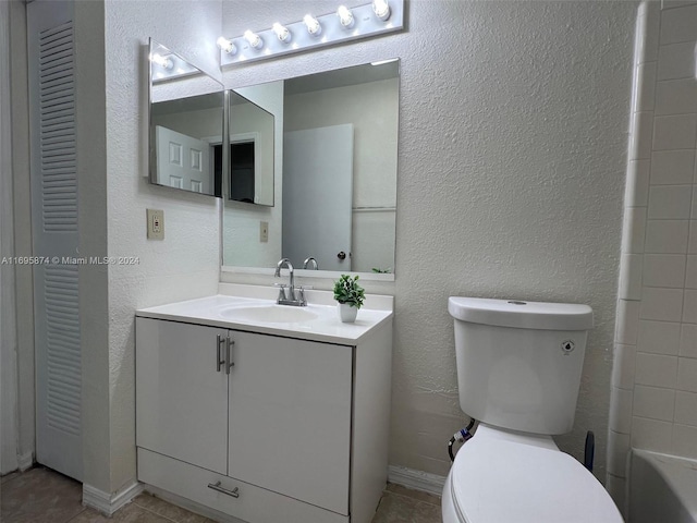 bathroom with tile patterned floors, vanity, and toilet