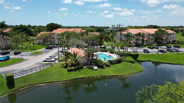 view of home's community featuring a water view and a yard