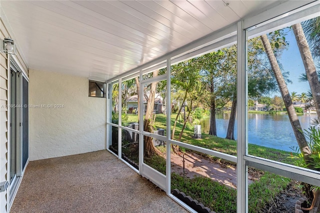 unfurnished sunroom with a water view