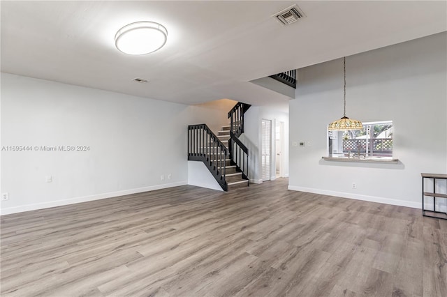 unfurnished living room with wood-type flooring