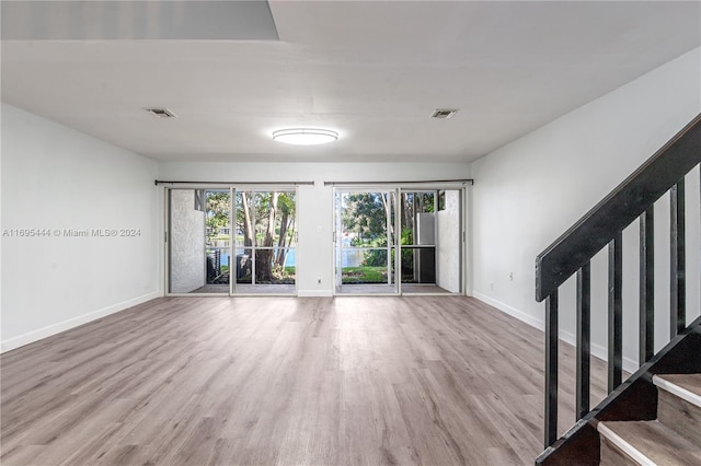 spare room featuring wood-type flooring