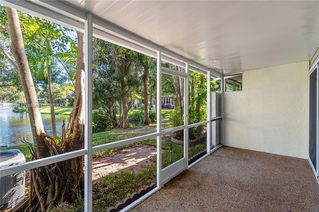 unfurnished sunroom featuring a healthy amount of sunlight and a water view