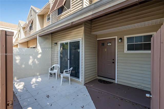 view of exterior entry featuring a patio area