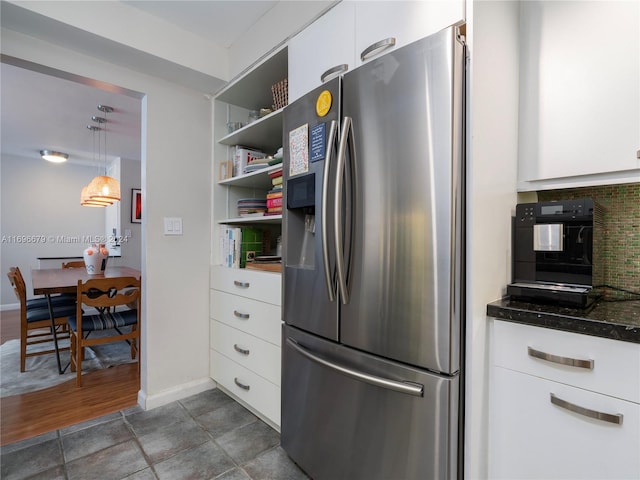 kitchen featuring white cabinets, dark hardwood / wood-style floors, pendant lighting, and stainless steel refrigerator with ice dispenser