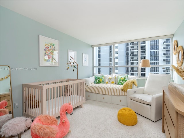 bedroom featuring a crib and carpet