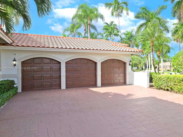 mediterranean / spanish-style house with a garage